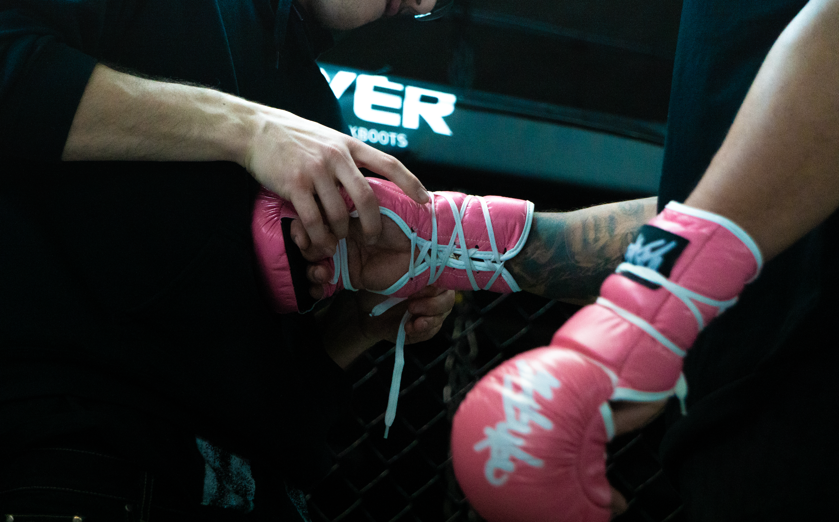 sleek mma and boxing gloves on black surface with dramatic lighting and modern feel